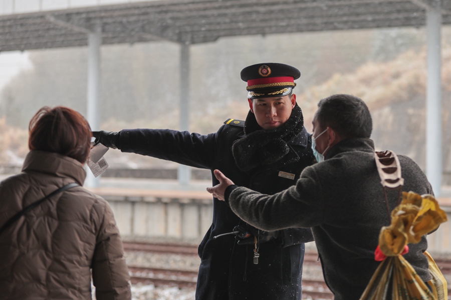 1月22日，在建宁县北站，铁路工作人员正在引导旅客候车。 张海根摄